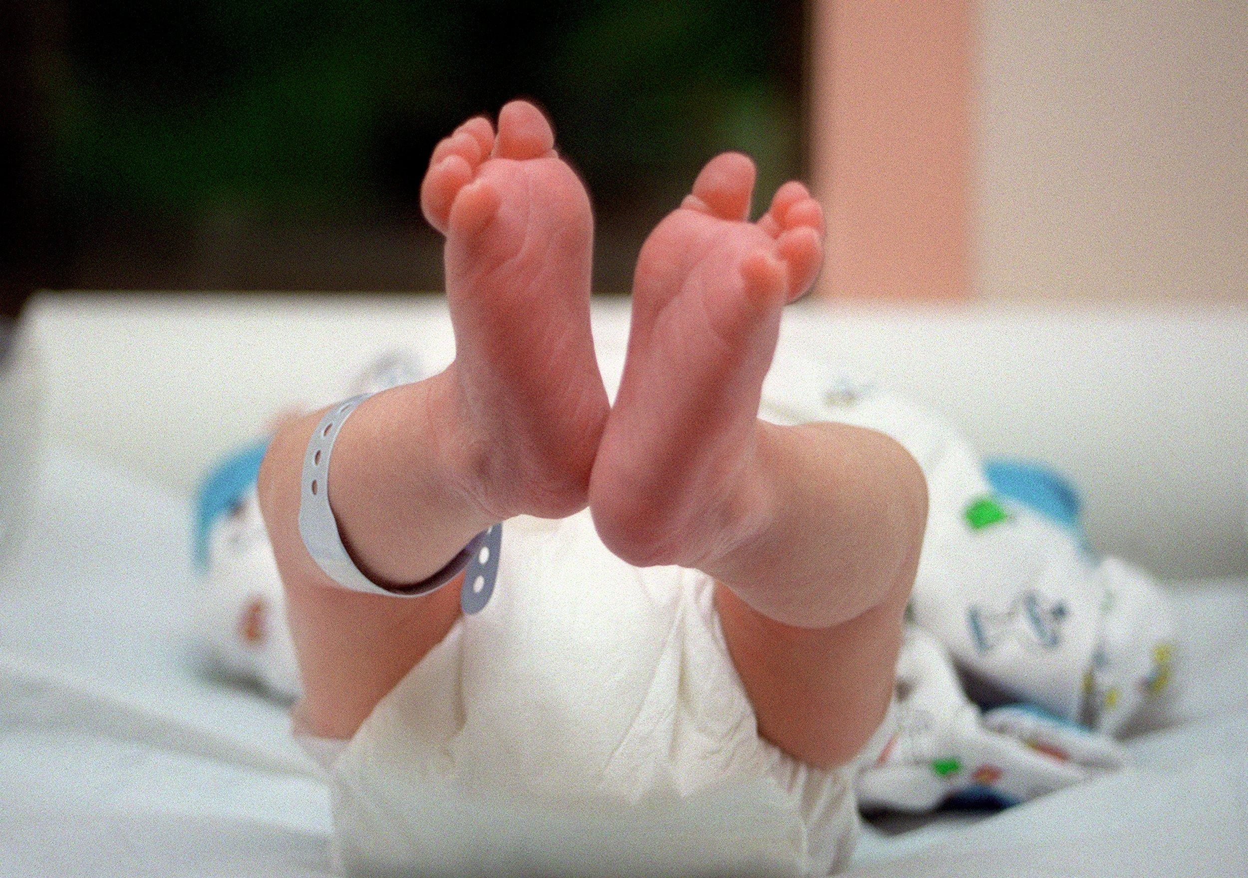 un nouveau-né est couché sur une table à langer, le 05 juin 2001 juste après sa naissance, au service maternité de l'hôpital franco-britannique de Levallois-Perret. (Photo by Didier PALLAGES / AFP)