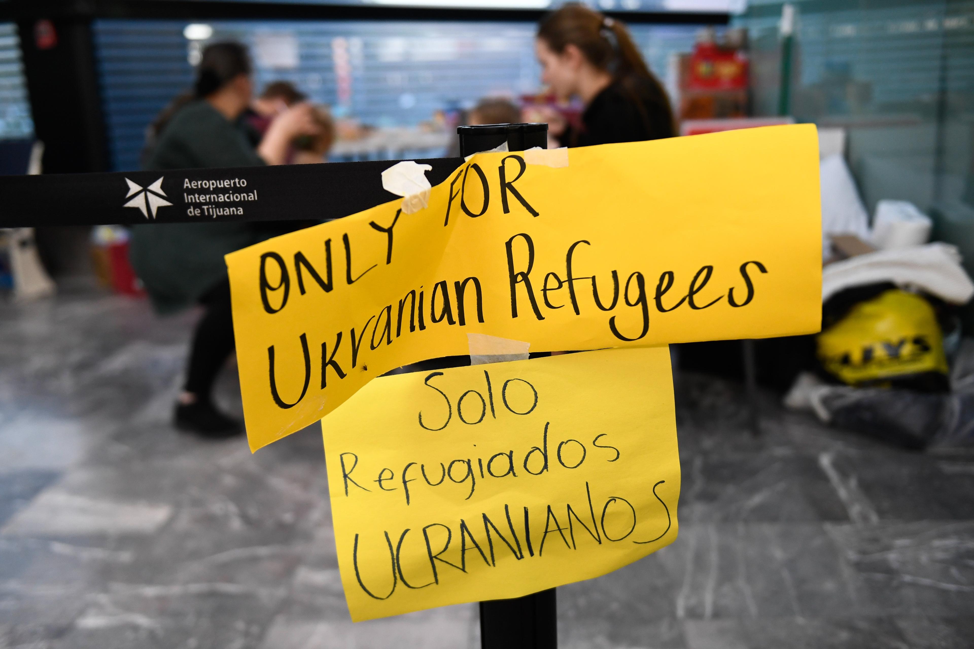 Żółty znak z angielskim i hiszpańskim napisem: "Tylko dla uchodźców z Ukrainy"