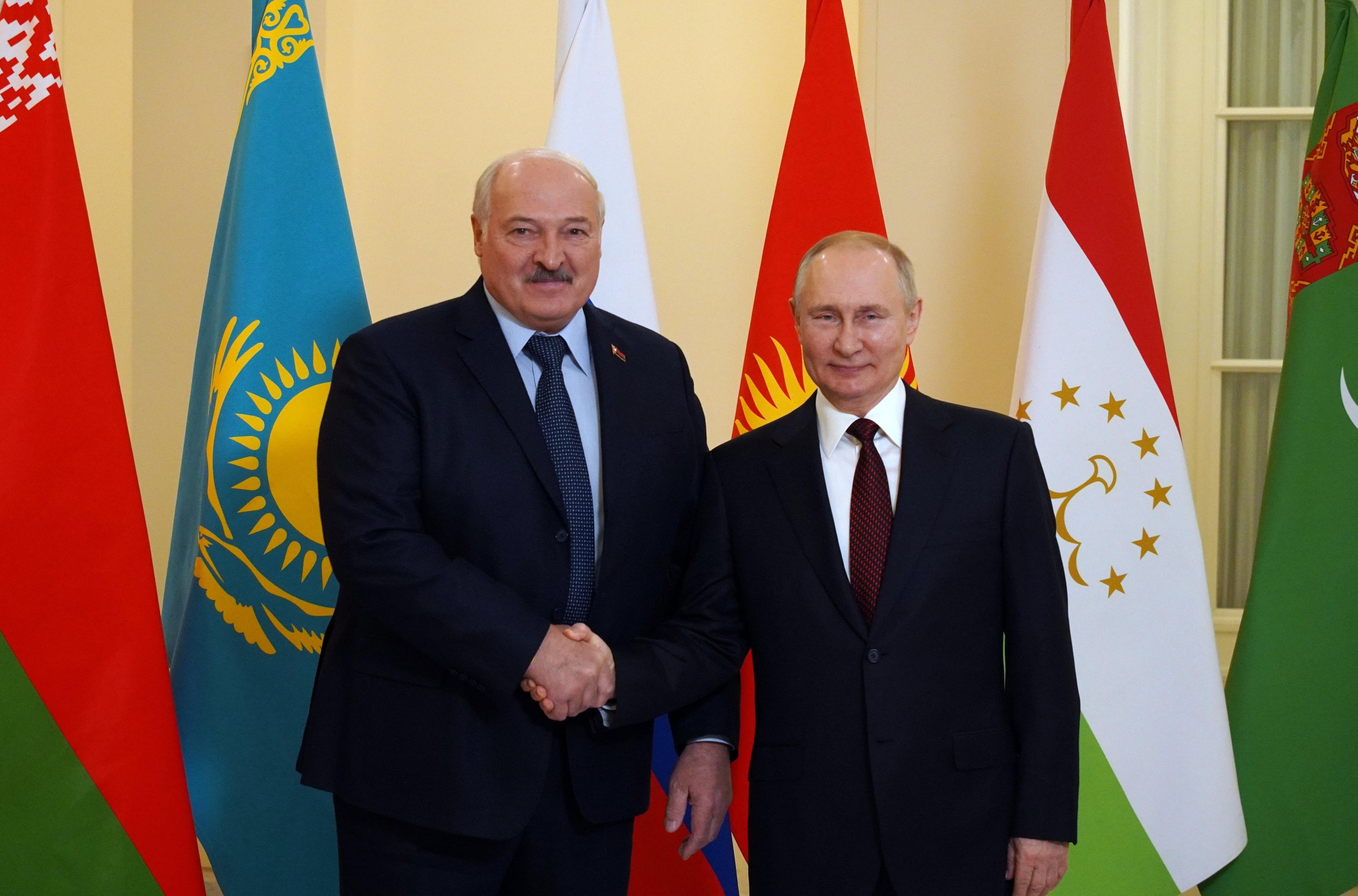 Russian President Vladimir Putin (R) greets Belarus' President Alexander Lukashenko ahead of an informal meeting of the heads of state of the Commonwealth of Independent States (CIS) at the Boris Yeltsin Presidential Library in Saint Petersburg on December 26, 2022. (Photo by Alexey DANICHEV / SPUTNIK / AFP)