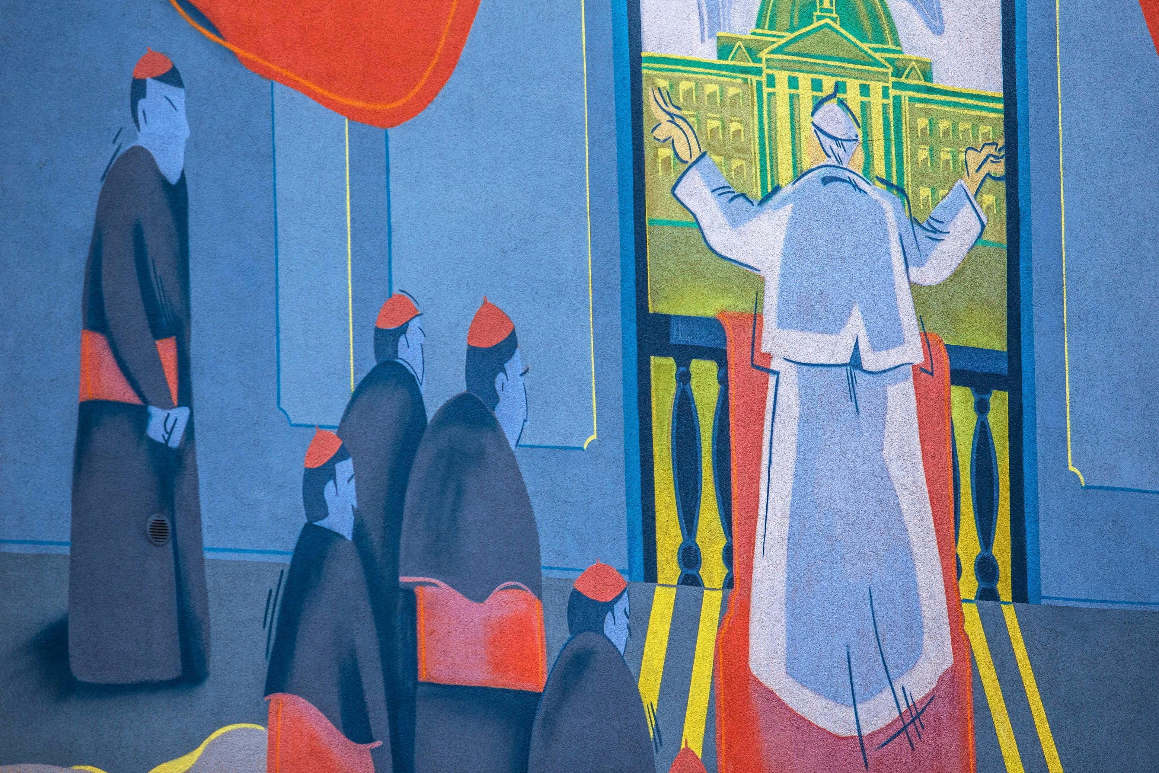 mural z modlącym się tyłem papieżem i klęczącymi przy nim biskupami