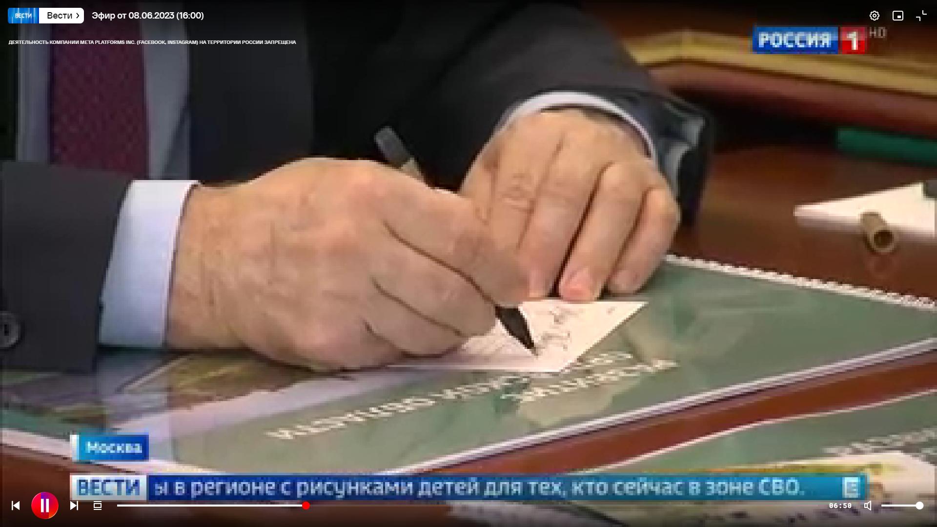 Zdjęcie ręki mężczyzny w garniturze podpisującego pocztówkę