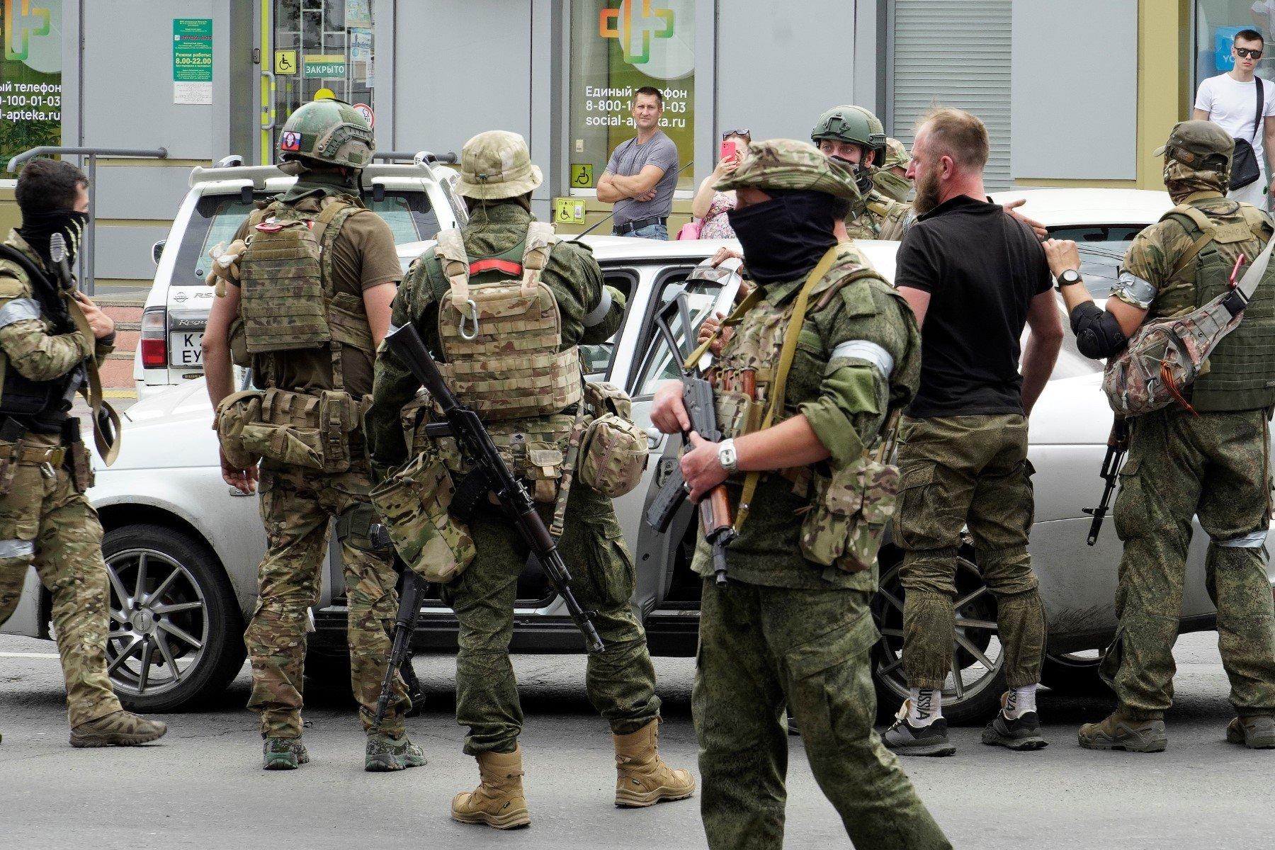 Members of Wagner group inspect a car in a street of Rostov-on-Don, on June 24, 2023. - President Vladimir Putin on June 24, 2023 said an armed mutiny by Wagner mercenaries was a "stab in the back" and that the group's chief Yevgeny Prigozhin had betrayed Russia, as he vowed to punish the dissidents. Prigozhin said his fighters control key military sites in the southern city of Rostov-on-Don. (Photo by STRINGER / AFP)