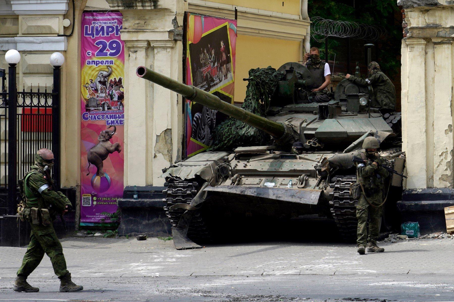 Members of Wagner group patrol in an area near a tank outside a circus building in the city of Rostov-on-Don, on June 24, 2023. - President Vladimir Putin on June 24, 2023 said an armed mutiny by Wagner mercenaries was a "stab in the back" and that the group's chief Yevgeny Prigozhin had betrayed Russia, as he vowed to punish the dissidents. Prigozhin said his fighters control key military sites in the southern city of Rostov-on-Don. (Photo by STRINGER / AFP)