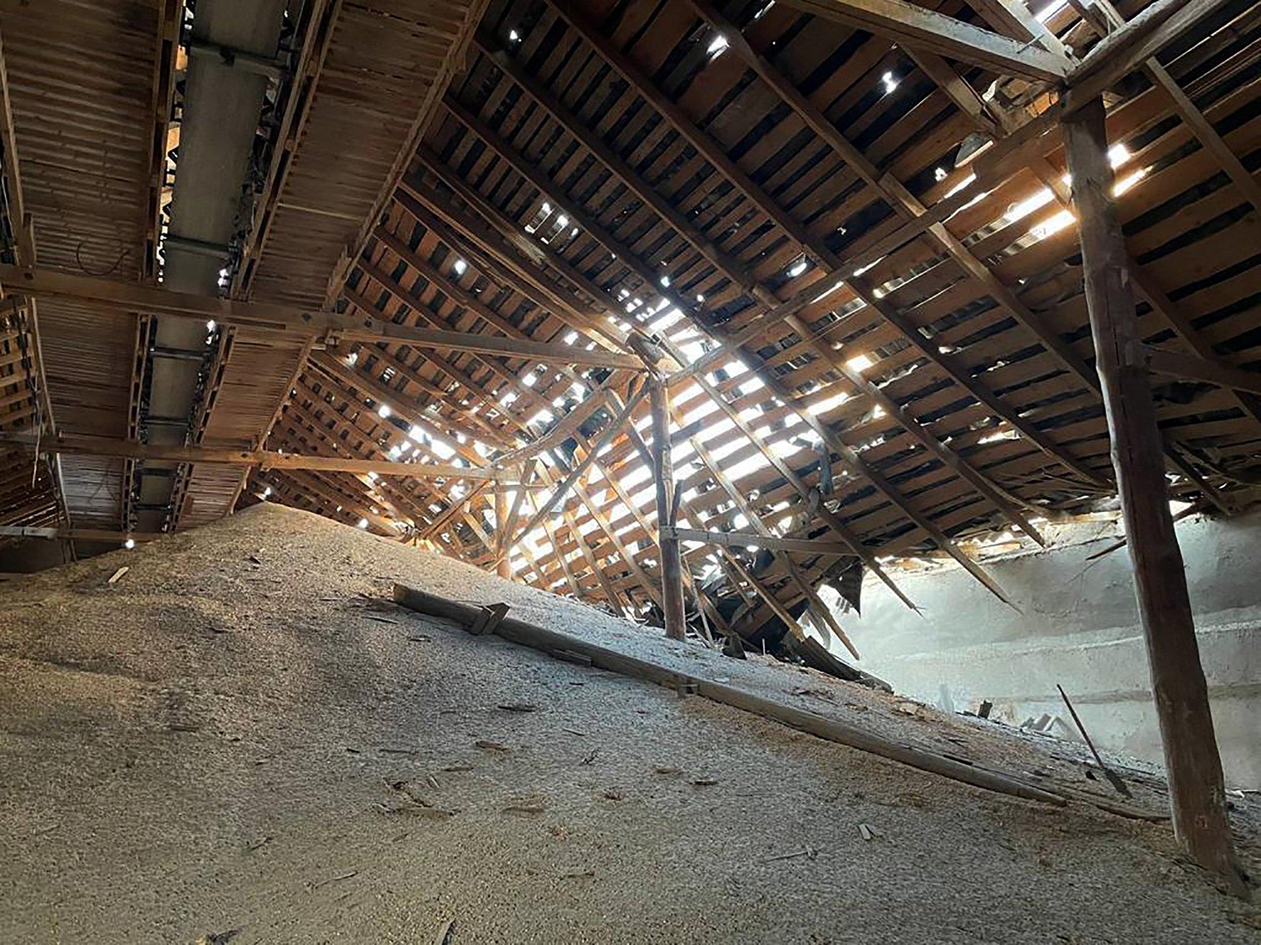 This handout photograph taken and released on September 13, 2023 by the press center of the Defense Forces of Southern Ukraine shows a damaged grain warehouse following Russian drone attacks in Odesa region, amid Russia's military invasion on Ukraine. - Russian drones struck the Danube river port of Izmail in southern Ukraine on September 13, the region's governor said, as Moscow continued to pound Kyiv's vital export routes. The Ukrainian military claimed 32 drones were downed during the attack, which the governor said injured several people and caused a fire. (Photo by Handout / press center of Defense Forces of the Southern Ukraine / AFP) / RESTRICTED TO EDITORIAL USE - MANDATORY CREDIT "AFP PHOTO / PRESS CENTER OF DEFENSE FORCES OF SOUTHERN UKRAINE" - NO MARKETING NO ADVERTISING CAMPAIGNS - DISTRIBUTED AS A SERVICE TO CLIENTS - RESTRICTED TO EDITORIAL USE - MANDATORY CREDIT "AFP PHOTO / Press Center of Defense Forces of Southern Ukraine" - NO MARKETING NO ADVERTISING CAMPAIGNS - DISTRIBUTED AS A SERVICE TO CLIENTS /