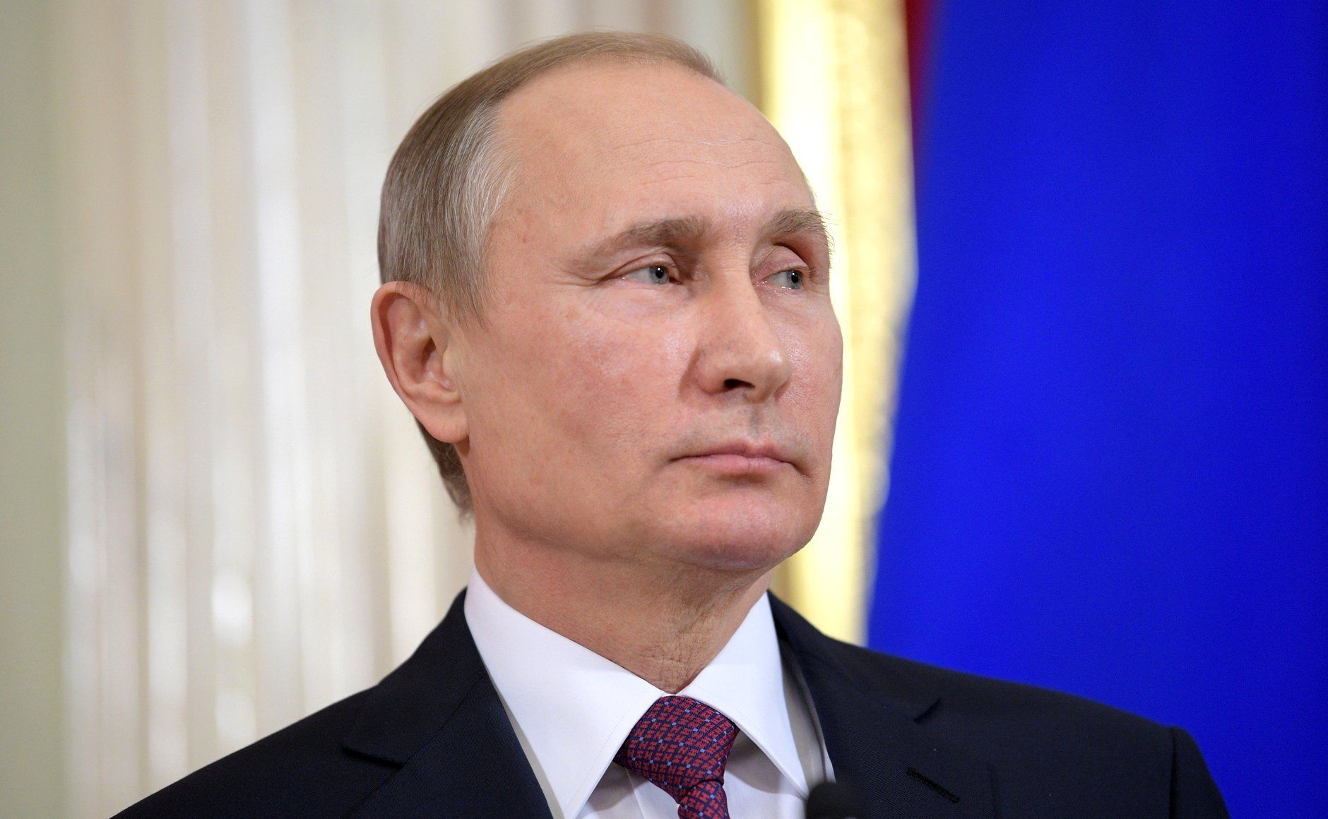 Władimir Putin na tle rosyjskiej flagi