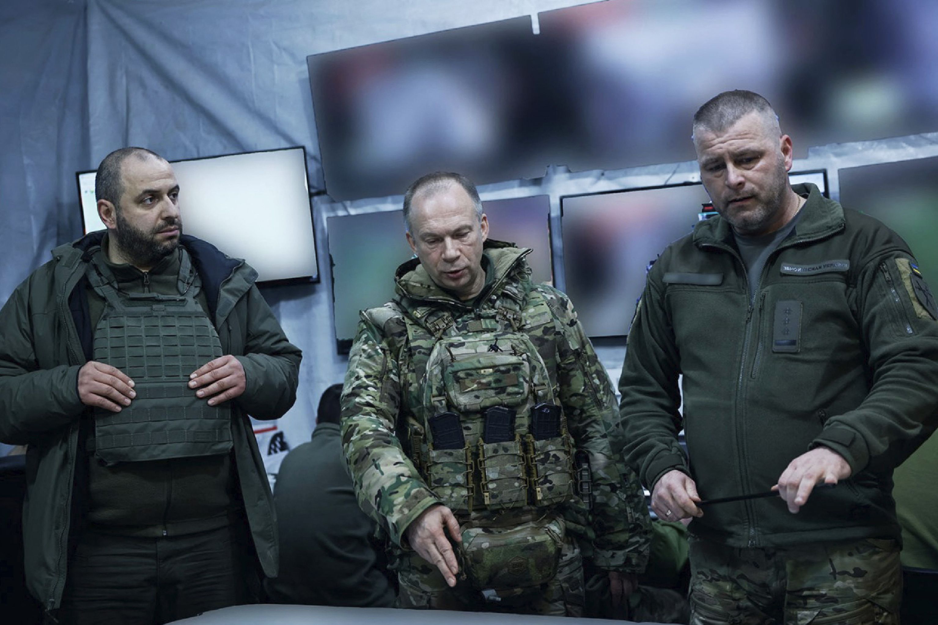 This handout photograph released on February 14, 2024, by Press service of Ukrainian Armed Forces, shows Commander-in-Chief of the Armed Forces of Ukraine Oleksandr Syrsky (C) and Ukraine's Defence Minister Rustem Umerov (L) visiting the frontline positions at an undisclosed location in eastern Ukraine. - Newly appointed Ukrainian military chief said on February 14, 2024 that the situation on the front line was precarious, following a visit to positions near Avdiivka and Kupiansk. (Photo by Handout / Armed Forces of Ukraine / AFP) / RESTRICTED TO EDITORIAL USE - MANDATORY CREDIT "AFP PHOTO / UKRAINIAN ARMED FORCES" - NO MARKETING NO ADVERTISING CAMPAIGNS - DISTRIBUTED AS A SERVICE TO CLIENTS - RESTRICTED TO EDITORIAL USE - MANDATORY CREDIT "AFP PHOTO / Ukrainian Armed Forces" - NO MARKETING NO ADVERTISING CAMPAIGNS - DISTRIBUTED AS A SERVICE TO CLIENTS /