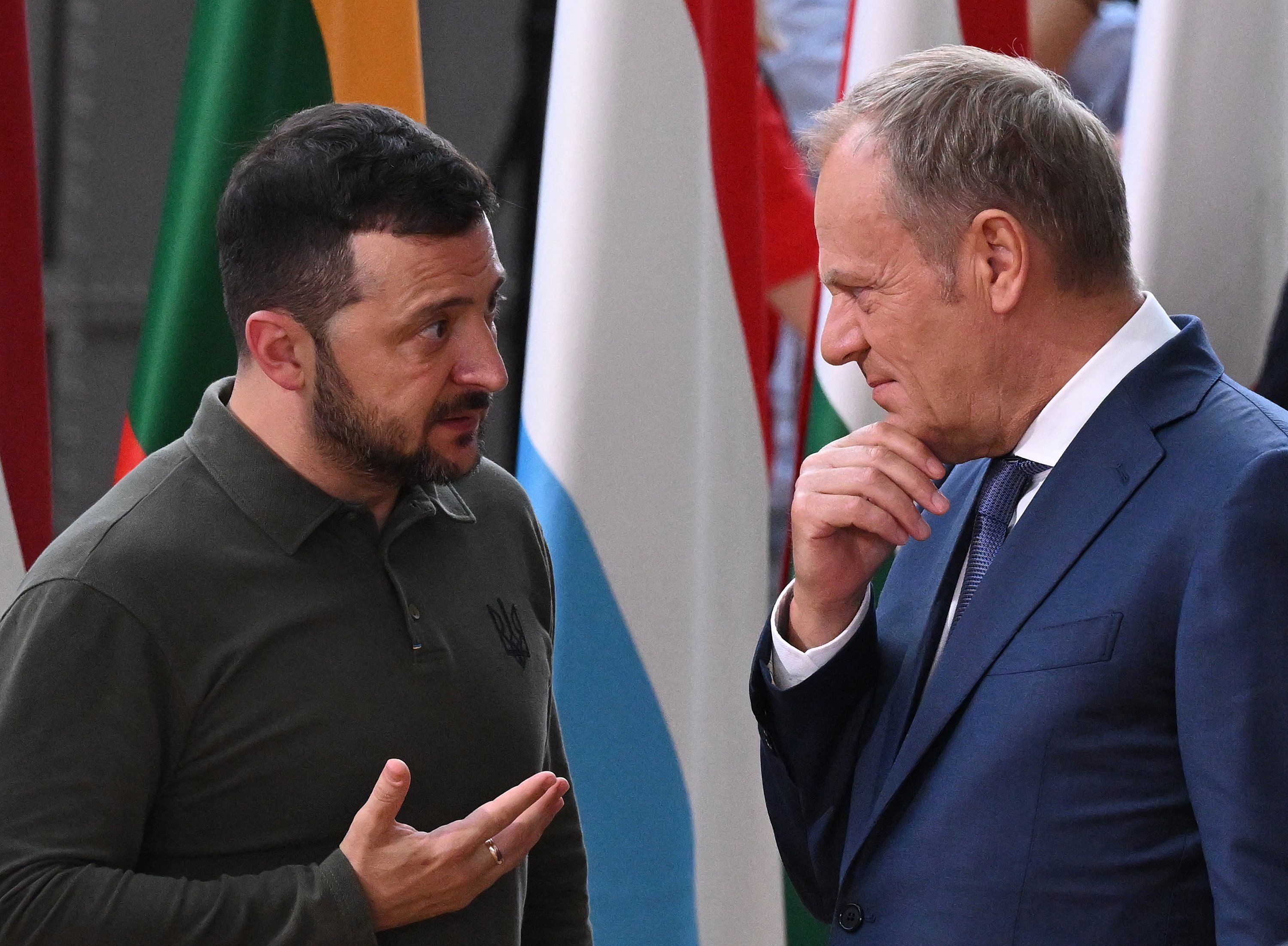 Ukrainian President Volodymyr Zelensky (L) talks with Poland's Prime Minister Donald Tusk during the European Council Summit at the EU headquarters in Brussels on June 27, 2024. (Photo by JOHN THYS / AFP)