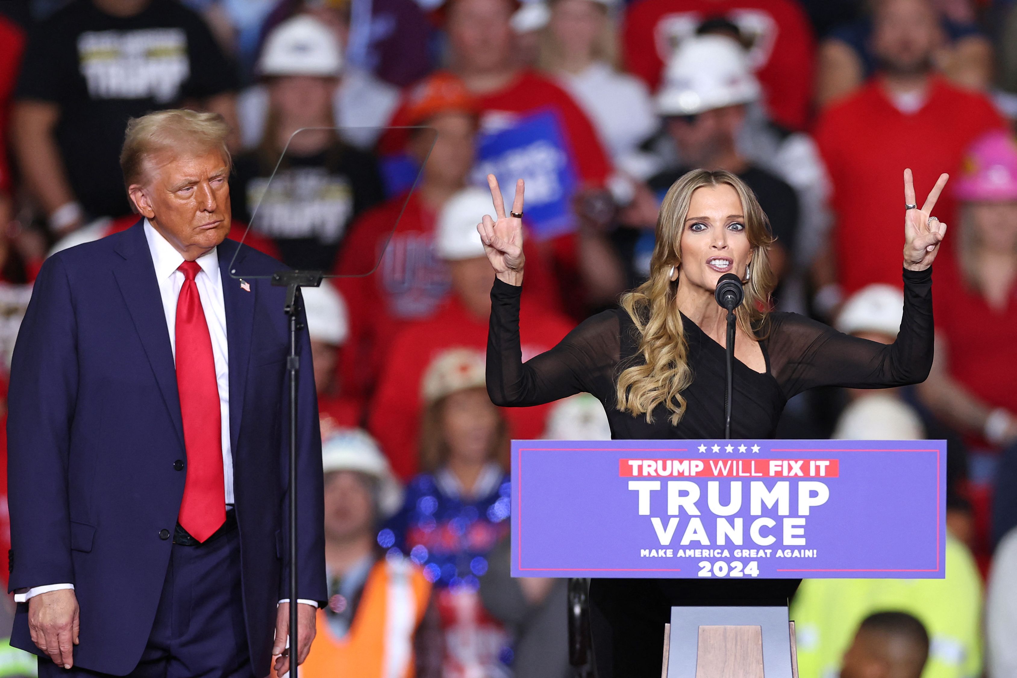 Former US President and Republican presidential candidate Donald Trump listens to US commentator and media personality Megyn Kelly (L) speak during a campaign rally at PPG Paints Arena in Pittsburgh, Pennsylvania on November 4, 2024. (Photo by CHARLY TRIBALLEAU / AFP)
