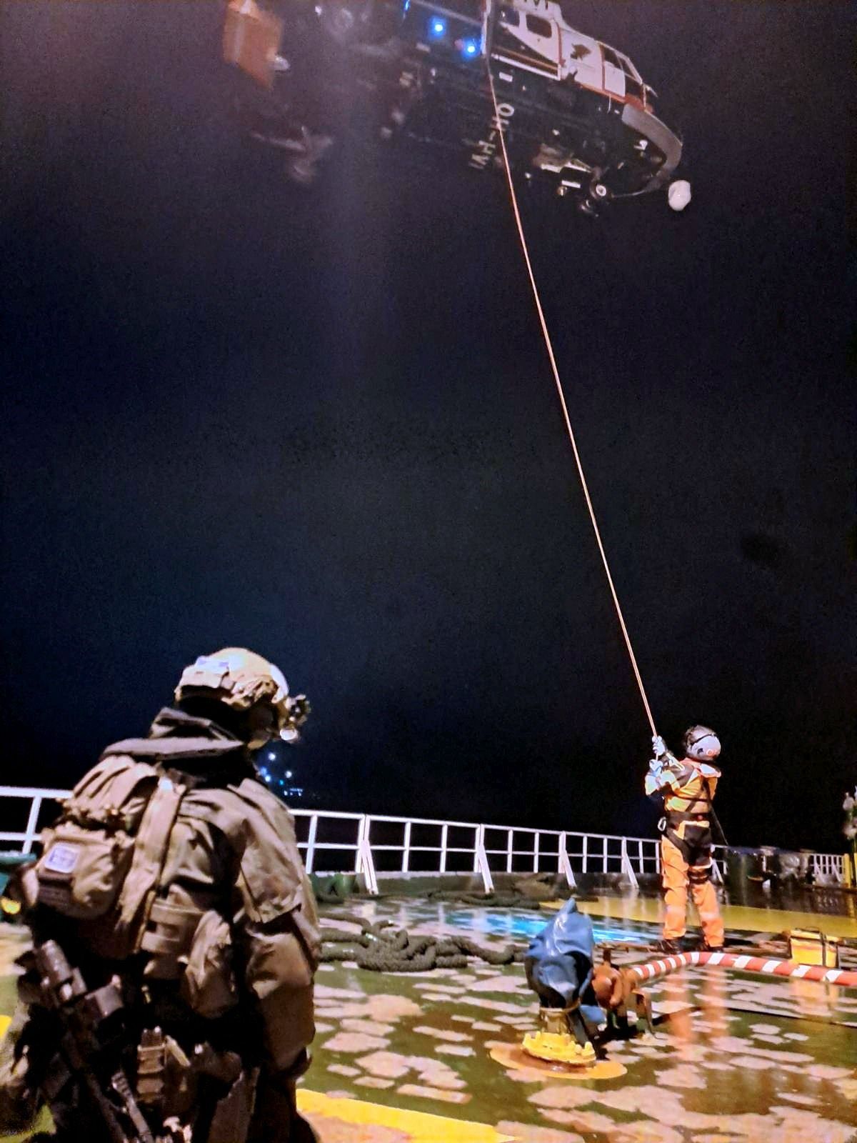 This handout picture released by The Finnish Border Guard on December 27, 2024 shows two Finnish officials on the deck of oil tanker Eagle S on the sea outside the Porkkalanniemi, Finland on December 27, 2024. - Finnish authorities said on December 26, 2024 that they were investigating an oil tanker that sailed from a Russian port for the "sabotage" of a power cable linking Finland and Estonia that was damaged the previous day. (Photo by Handout / Finnish Border Guard / AFP) / RESTRICTED TO EDITORIAL USE - MANDATORY CREDIT "AFP PHOTO /FINNISH BORDER GUARD" - NO MARKETING - NO ADVERTISING CAMPAIGNS - DISTRIBUTED AS A SERVICE TO CLIENTS