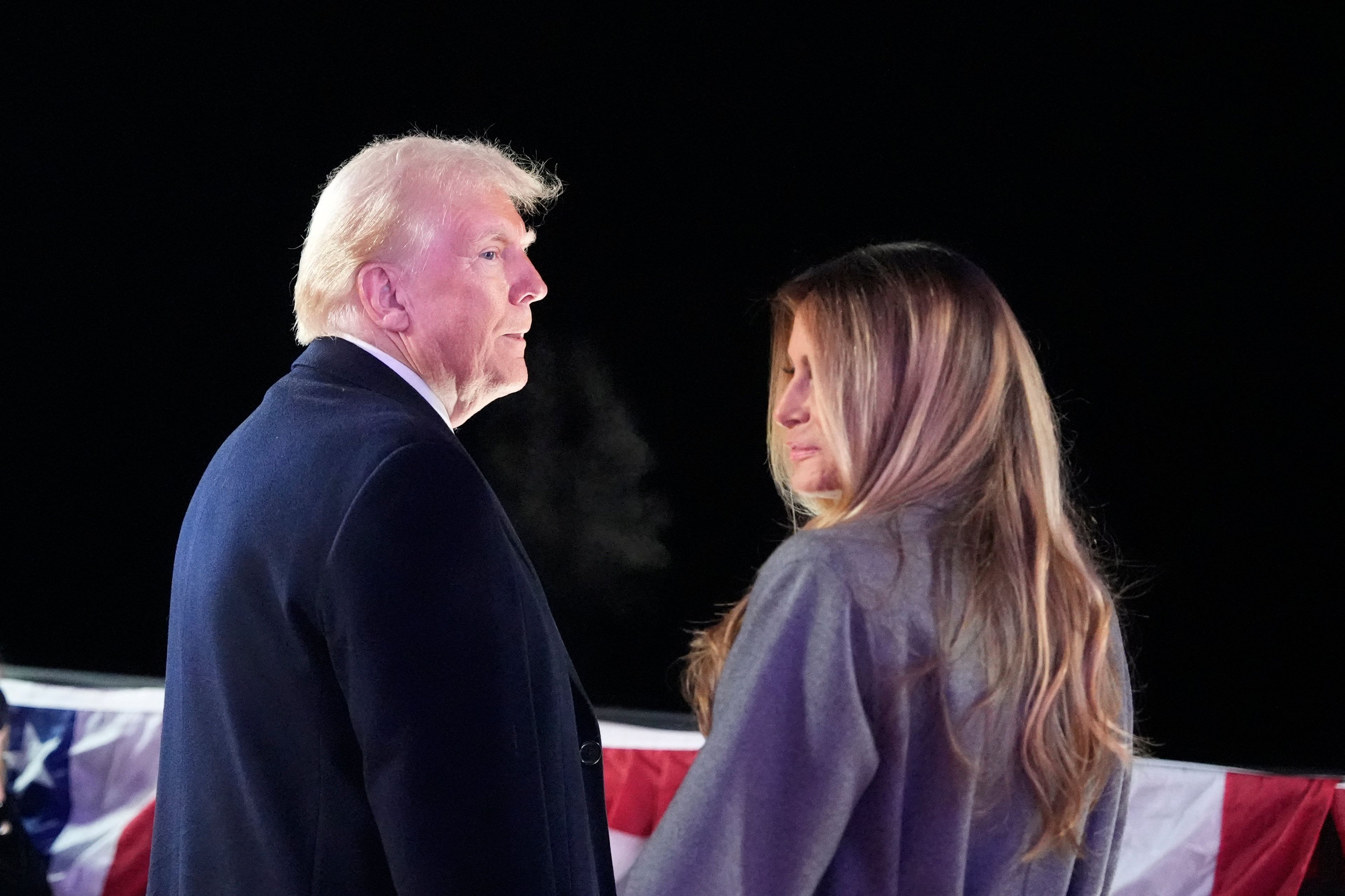 US President-elect Donald Trump and his wife Melania Trump stand to watch fireworks during a reception in his honor at Trump National Golf Club Washington DC in Sterling, Virginia, on January 18, 2025. (Photo by Alex Brandon / POOL / AFP)