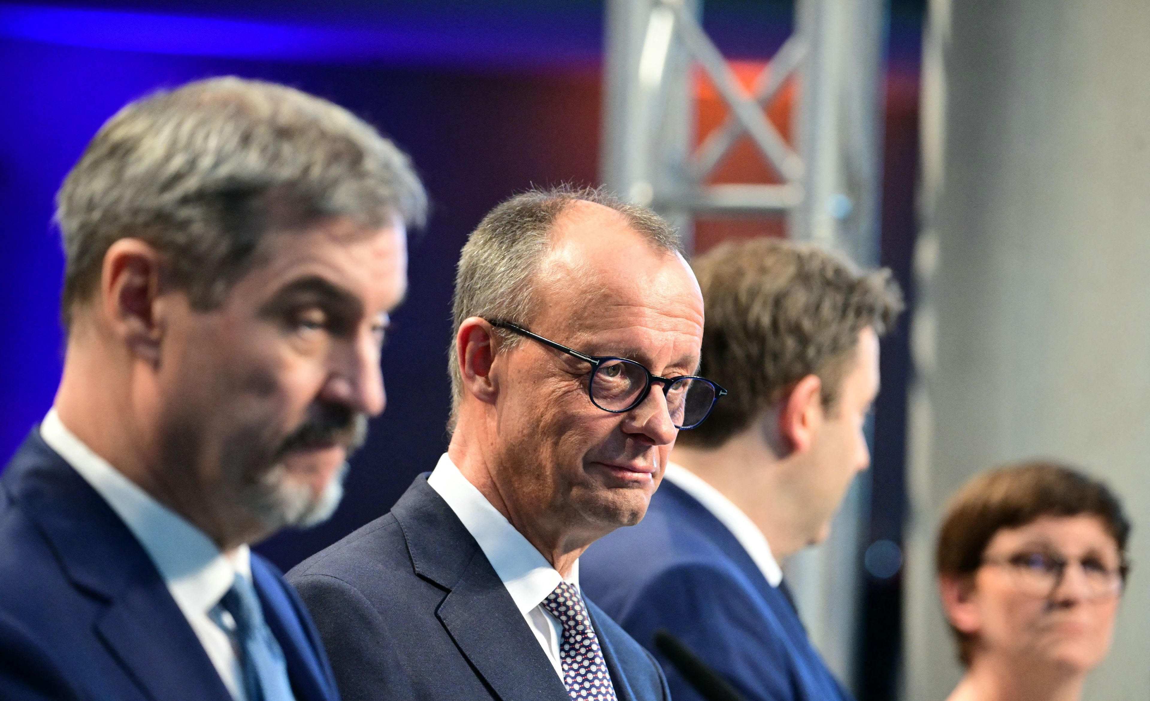 Trzech mężczyzn i kobieta stoją na scenie