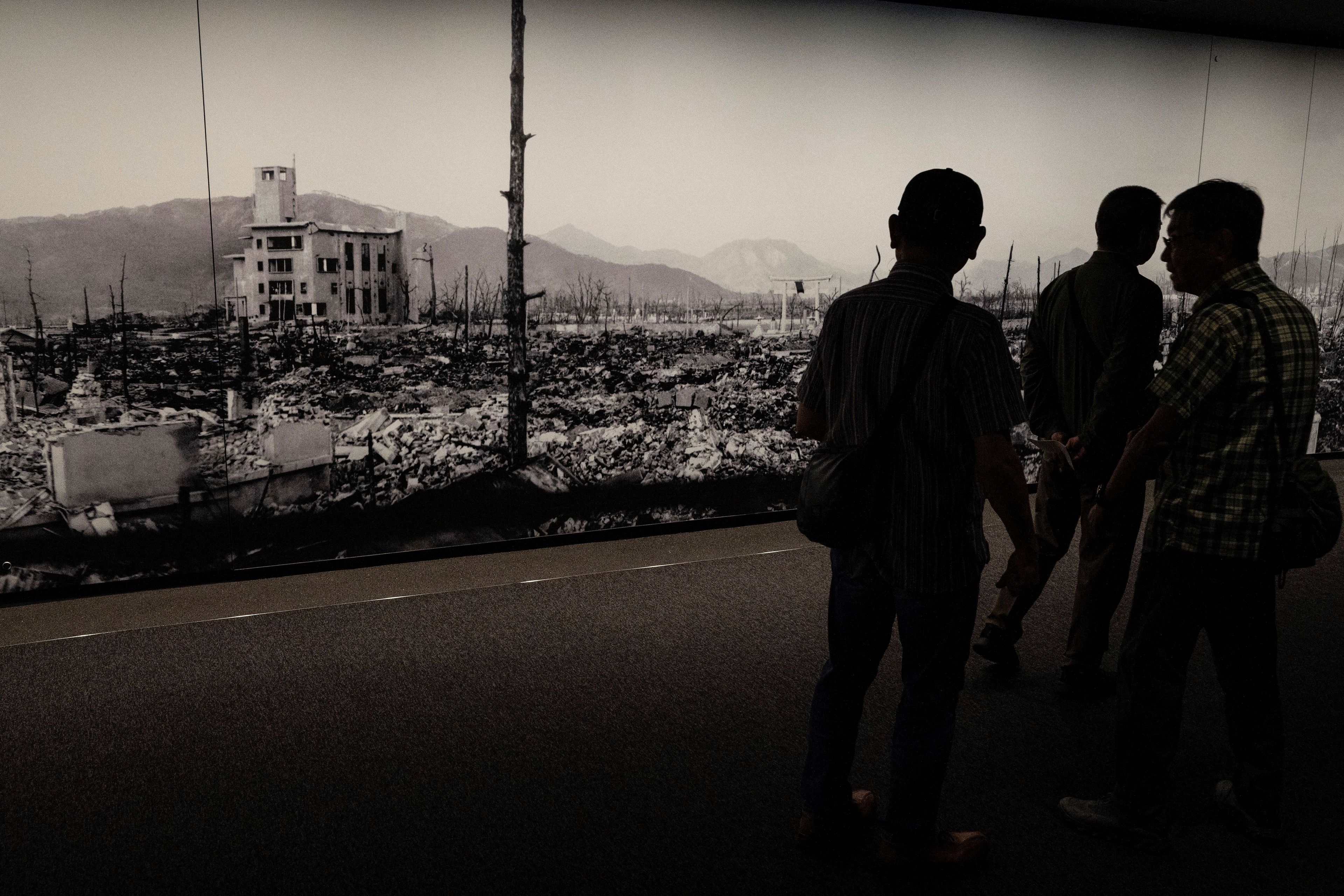 This photo taken on May 15, 2023 shows visitors looking at displays with information about the 1945 atomic bombing, at the Hiroshima Peace Memorial Museum in Hiroshima, just days ahead of the arrival of leaders for the G7 Leaders' Summit. G7 leaders meet in Hiroshima from May 19-21, looking to tighten the screws further on Russia over the Ukraine war and agree a united line on China's growing military and economic power. (Photo by Richard A. Brooks / AFP)