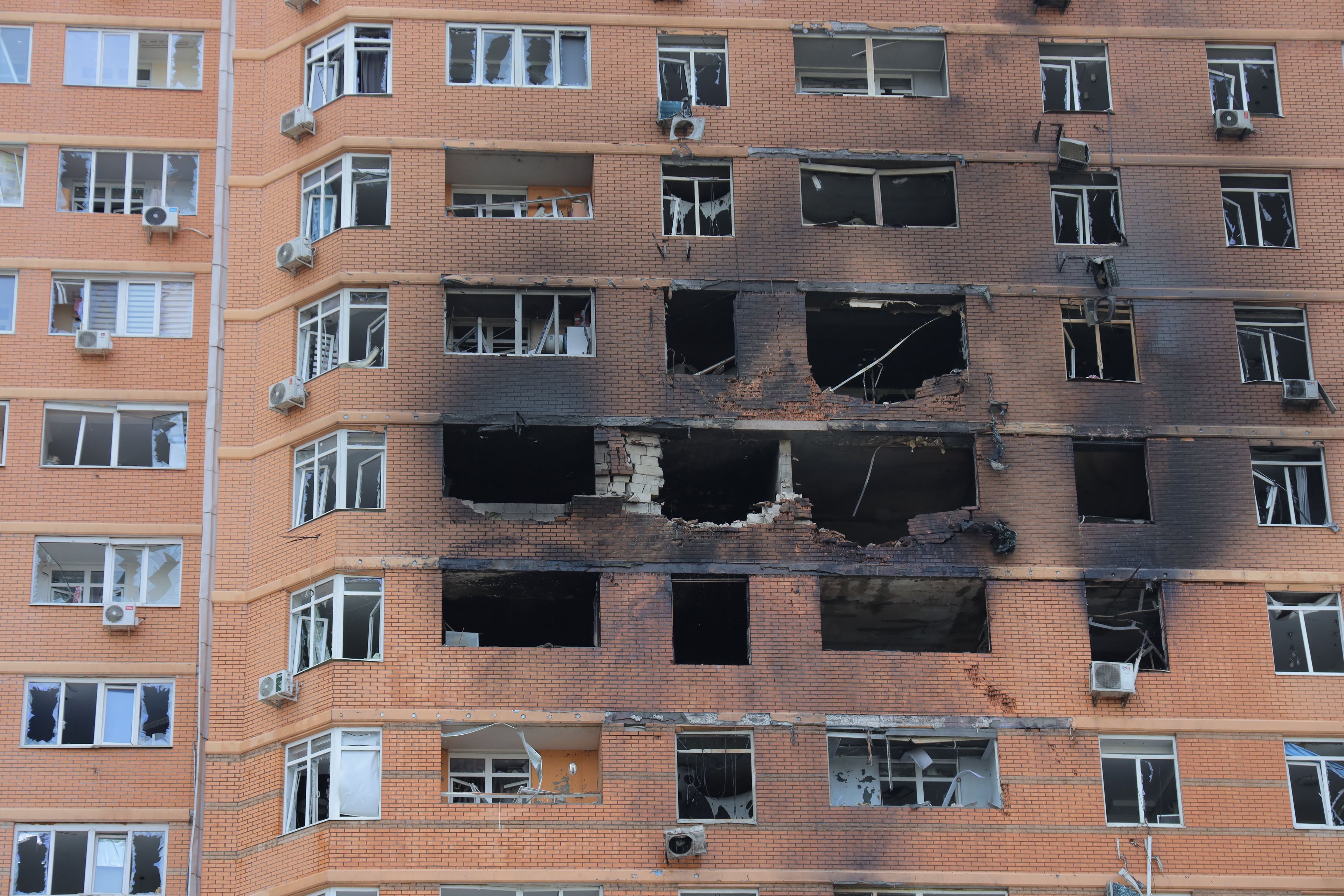 This photograph shows a multi-storey residential building damaged after a Russian drone attack in Odesa on June 28, 2025, amid the Russian invasion of Ukraine. A Russian drone strike on Ukraine's southern port city of Odesa killed two people and wounded 14, including children, local authorities said. Moscow has stepped up drone and missile attacks on Ukraine and peace talks initiated by the United States to end the three-year conflict have stalled. (Photo by Oleksandr GIMANOV / AFP)
