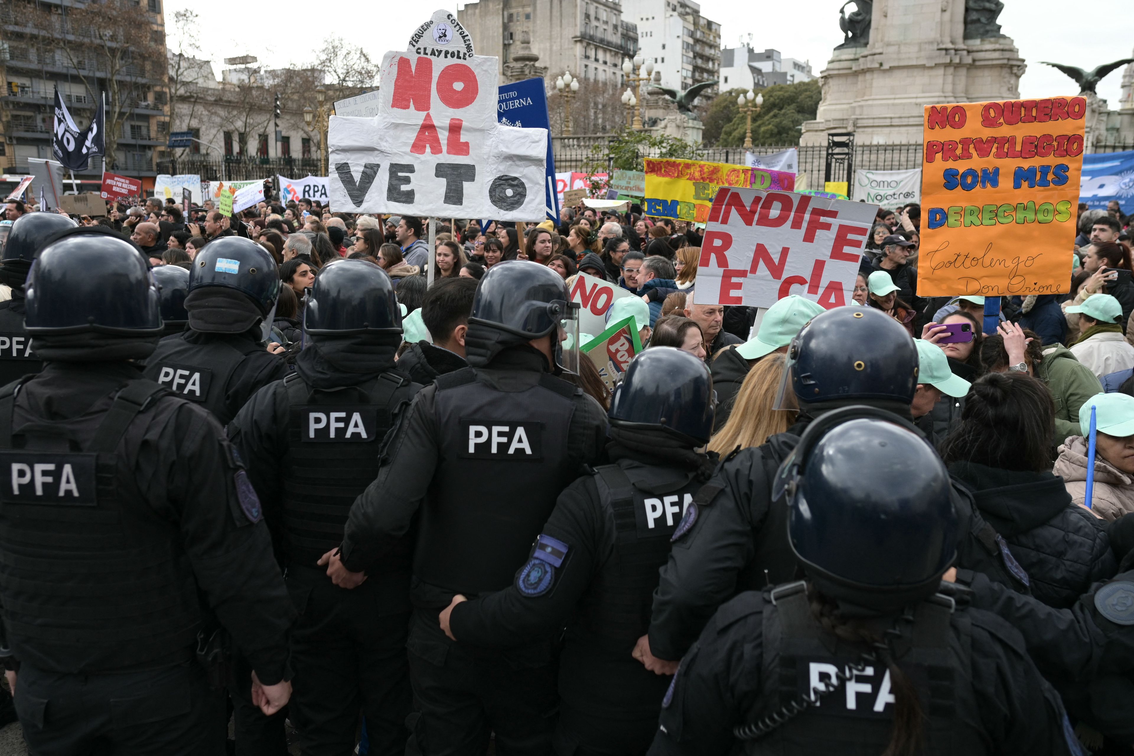 People with disabilities, their families, and healthcare workers protest against Argentine President Javier Milei's veto of a law that would have increased retirement and disability pensions outside Congress in Buenos Aires on August 5, 2025. Argentina's President Javier Milei vetoed the law granting an increase in retirement and disability pensions approved by a majority in Congress last July, arguing that it undermined his fiscal balance policy, according to the text published on August 4 in the official gazette. (Photo by Juan Mabromata / AFP)
