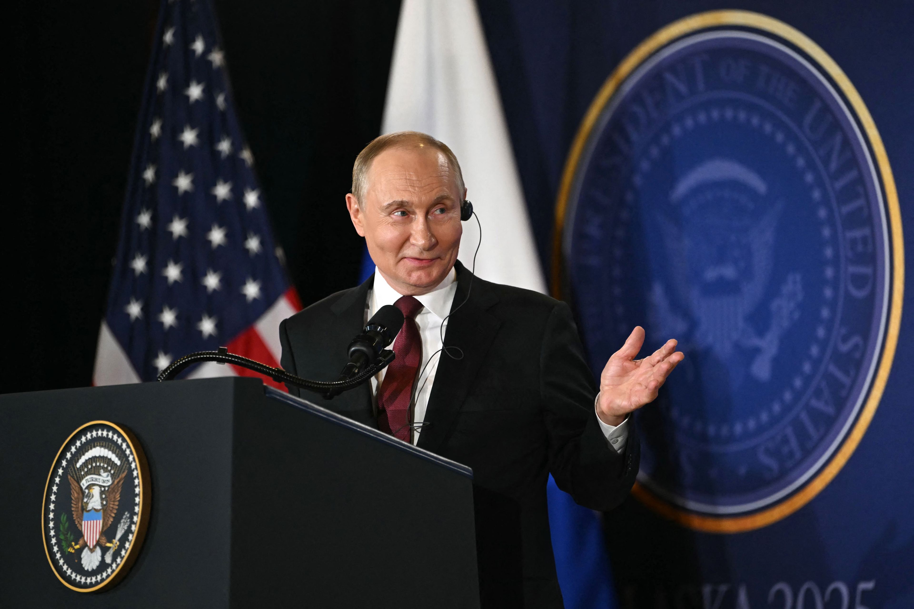 Russian President Vladimir Putin gestures as he speaks during a joint press conference with US President Donald Trump (out of frame) after participating in a US-Russia summit on Ukraine at Joint Base Elmendorf-Richardson in Anchorage, Alaska, on August 15, 2025. (Photo by ANDREW CABALLERO-REYNOLDS / AFP)