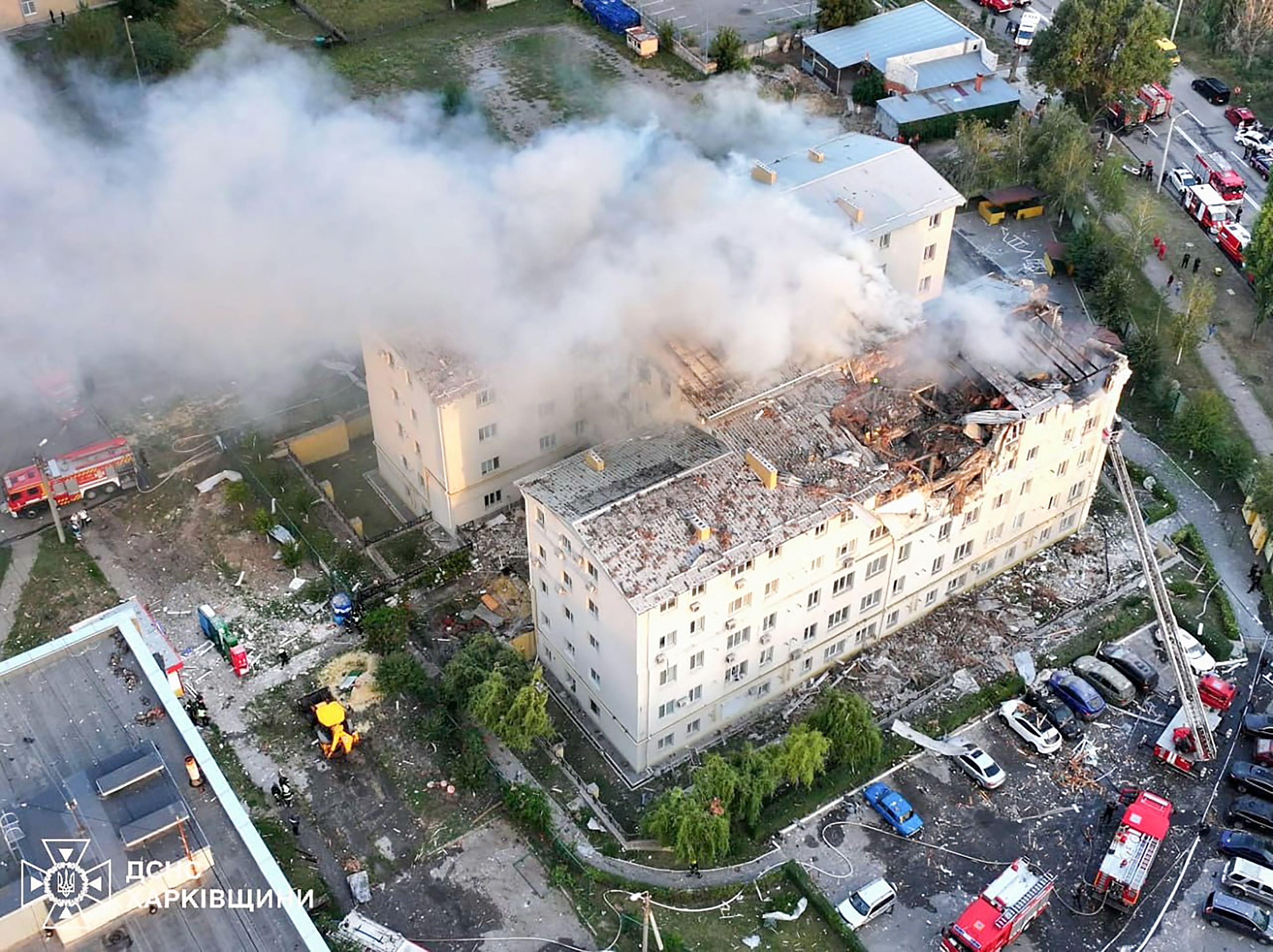 This handout photograph taken and released by the Ukrainian Emergency Service on August 18, 2025, shows a damaged residential building following an air attack, in Kharkiv, amid the Russian invasion of Ukraine. Three people were killed and more than a dozen wounded by an overnight Russian drone strike on Ukraine's Kharkiv, the mayor Igor Terekhov said on August 18, 2025. (Photo by Handout / UKRAINIAN EMERGENCY SERVICE / AFP) / RESTRICTED TO EDITORIAL USE - MANDATORY CREDIT "AFP PHOTO / UKRAINIAN EMERGENCY SERVICE / HANDOUT /  " - NO MARKETING NO ADVERTISING CAMPAIGNS - DISTRIBUTED AS A SERVICE TO CLIENTS