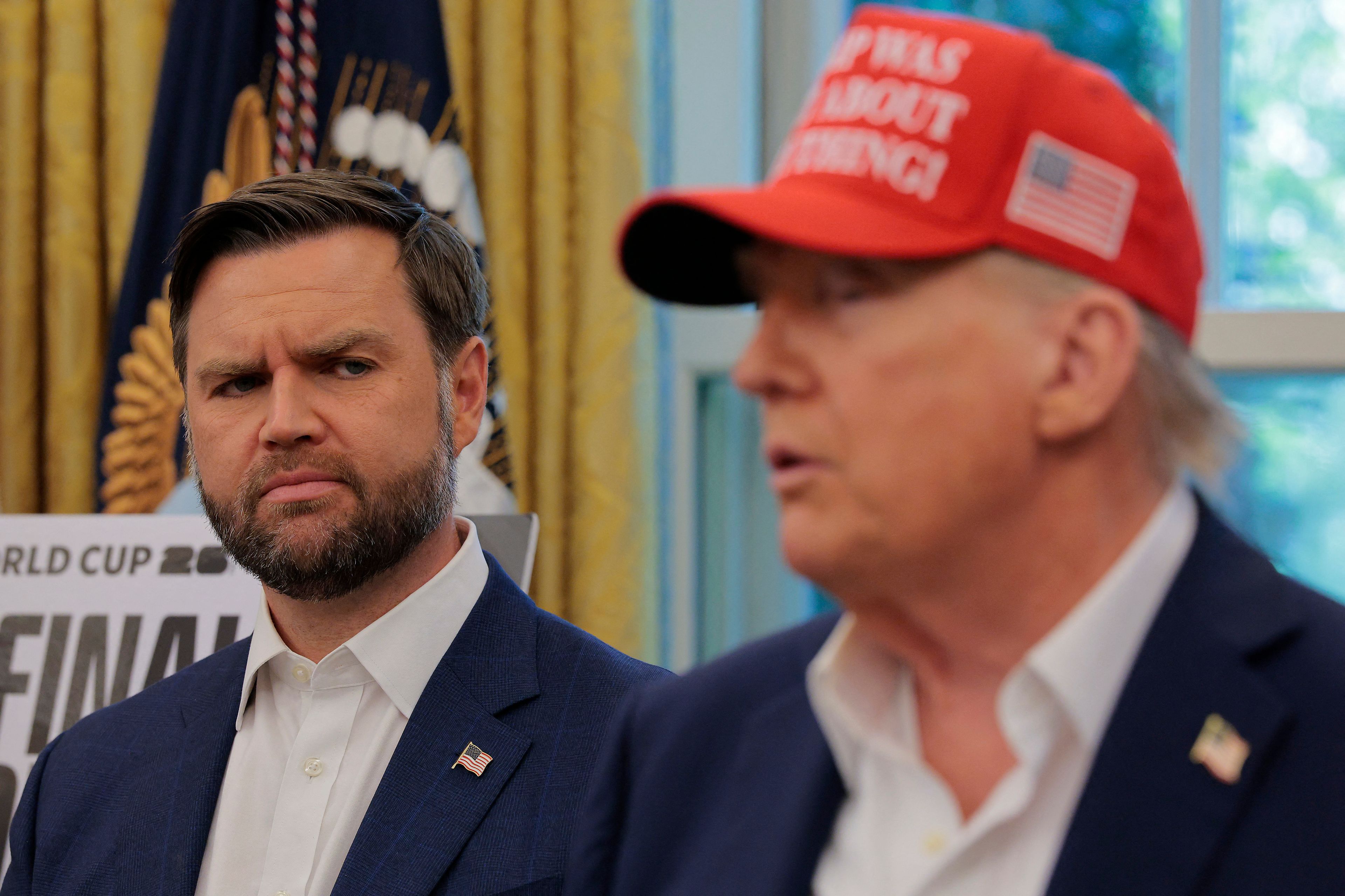 WASHINGTON, DC - AUGUST 22: Vice President JD Vance looks at U.S. President Donald Trump as he talks in the Oval Office August 22, 2025 in Washington, DC. Trump announced the FIFA World Cup 2026 draw will take place at The Kennedy Center.   Chip Somodevilla/Getty Images/AFP (Photo by CHIP SOMODEVILLA / GETTY IMAGES NORTH AMERICA / Getty Images via AFP)