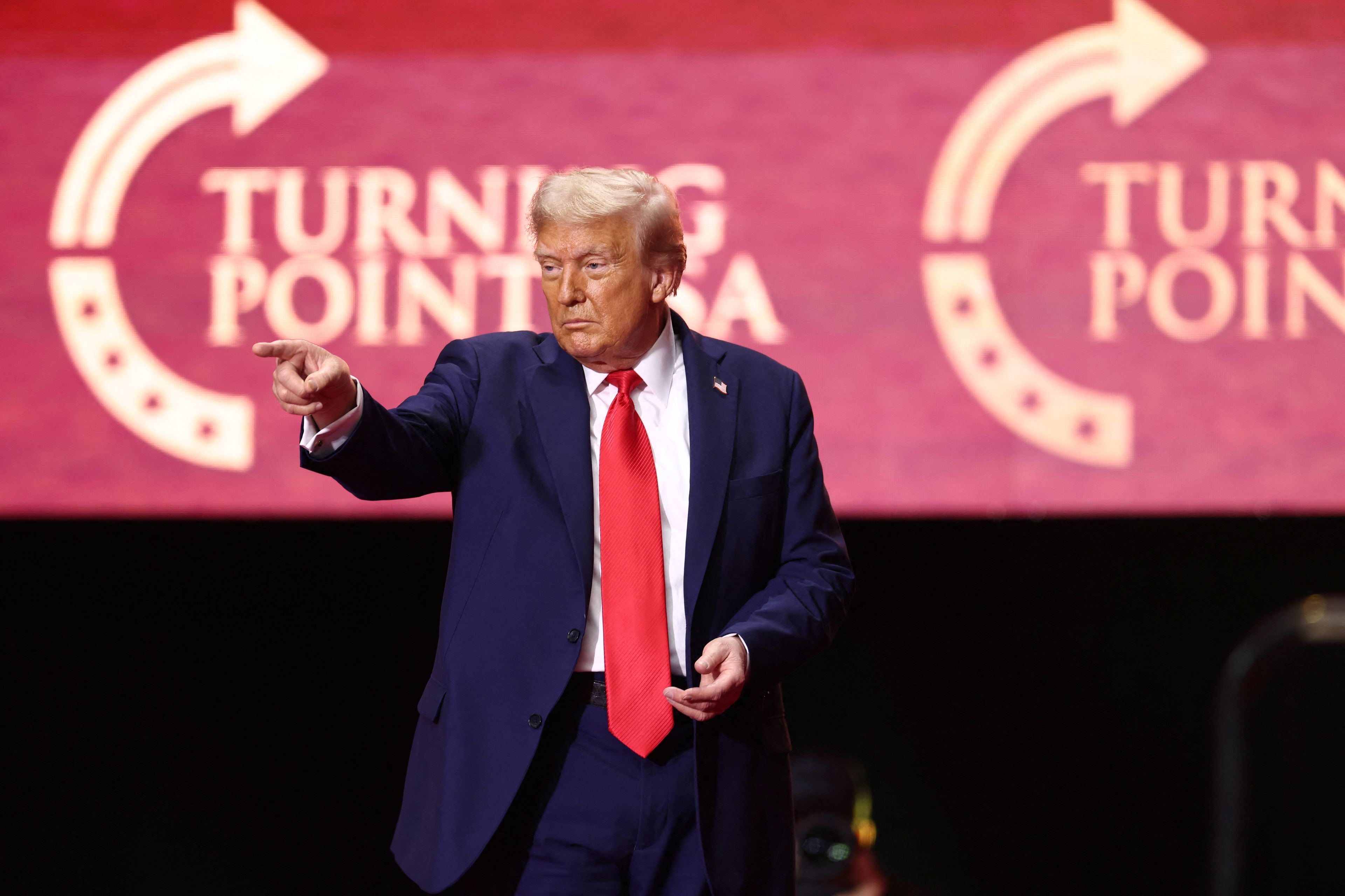 US President Donald Trump reacts after speaking at the public memorial service for right-wing activist Charlie Kirk at State Farm Stadium in Glendale, Arizona, on September 21, 2025. (Photo by CHARLY TRIBALLEAU / AFP)