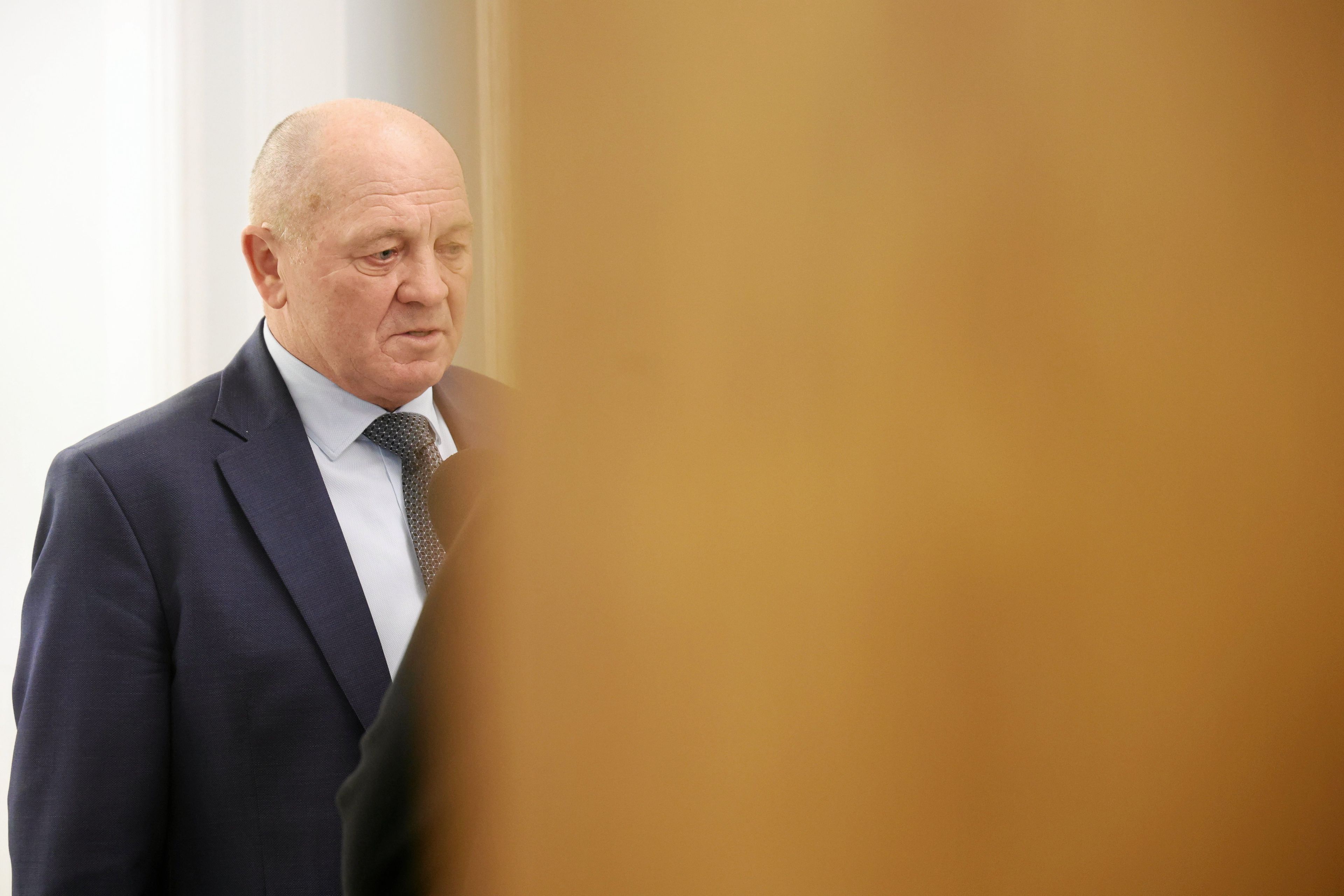 Męzczyzna widziany zza futryny drzwi