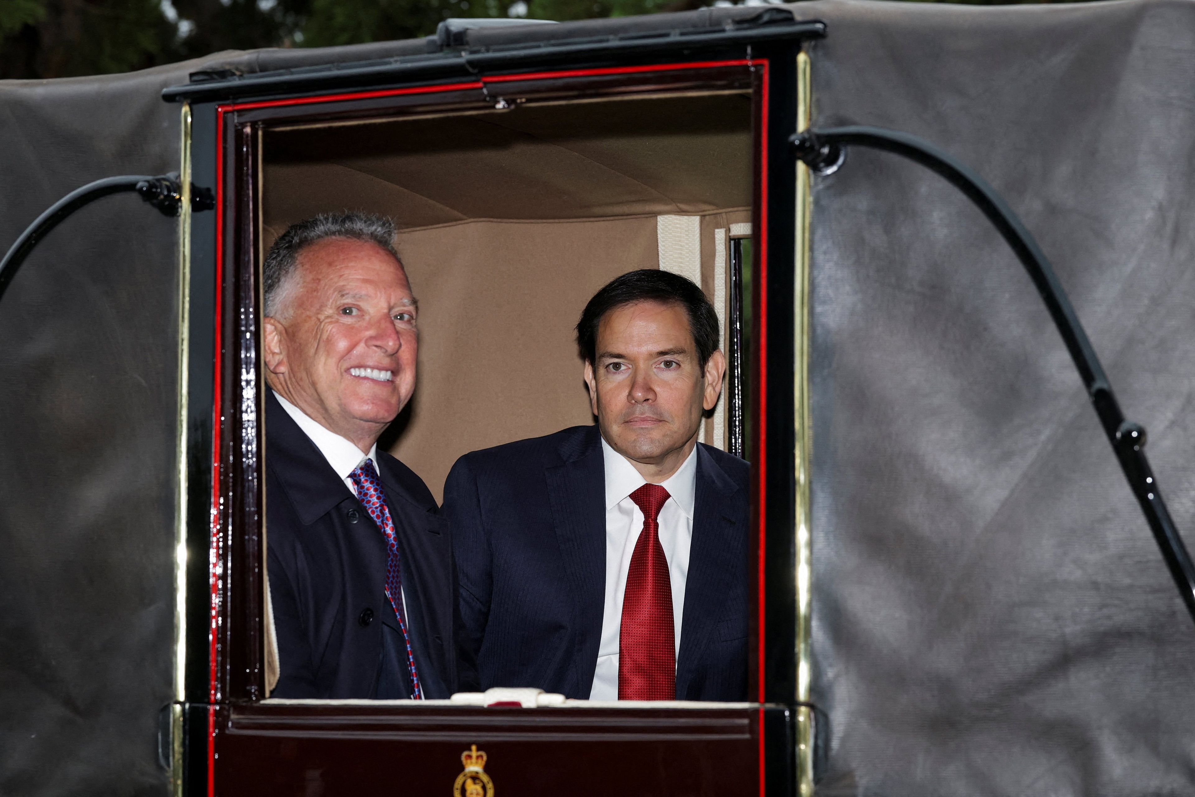 US Secretary of State Marco Rubio and US Special Envoy Steve Witkoff travel in the Ascot Landau carriage during a horse-drawn procession towards Windsor Castle, in Windsor, on September 17, 2025, during a second State Visit. US President Donald Trump arrived in Britain for an unprecedented second State Visit, with the UK government rolling out a royal red carpet welcome to win over the mercurial leader. (Photo by Toby Melville / POOL / AFP)