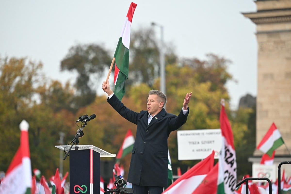 Leader of the opposition party TISZA (Respect and Freedom) Peter Magyar addresses participants near Heroes' Square in central Budapest on October 23, 2025, during an event commemorating the 69th anniversary of the Hungarian uprising against the Soviet occupation in 1956. Tens of thousands of Hungarians gathered in Budapest on Thursday at rival rallies, as the government and the opposition each look to drum up support ahead of tense elections next year. (Photo by Attila KISBENEDEK / AFP)