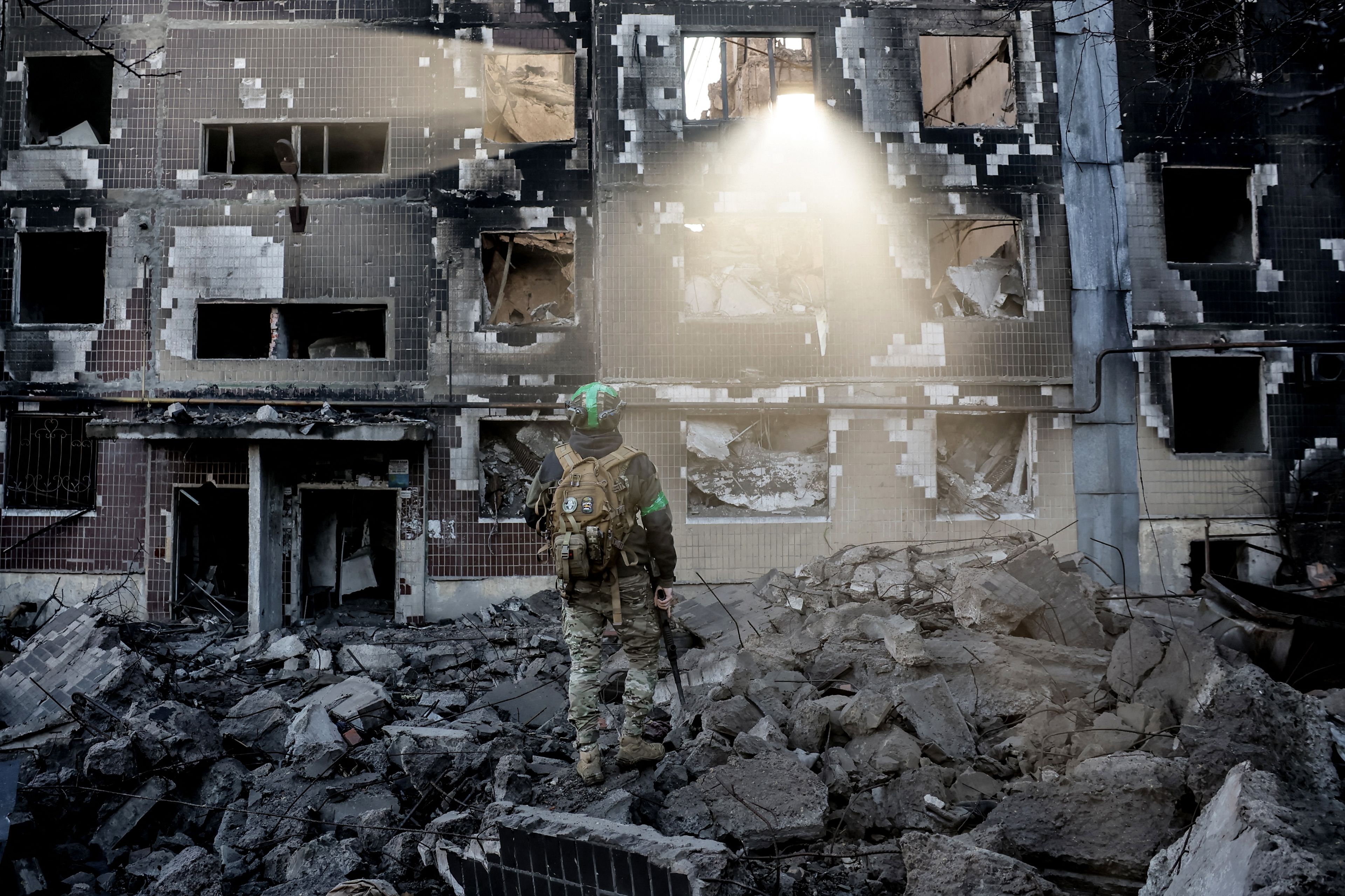 In this handout photograph taken by the press service of the 24th Mechanized Brigade of Ukrainian Armed Forces on November 15, 2025 and released on November 17, 2025, a Ukrainian serviceman stands among the rubble in the courtyard of a destroyed residential building in the frontline town of Kostyantynivka, Donetsk region, amid the Russian invasion of Ukraine. (Photo by OLEG PETRASIUK / 24th Mechanized Brigade of Ukrainian Armed Forces / AFP) / RESTRICTED TO EDITORIAL USE - MANDATORY CREDIT "AFP PHOTO / OLEG PETRASIUK/ 24TH MECHANIZED BRIGADE OF UKRAINIAN ARMED FORCES" -  HANDOUT - NO MARKETING NO ADVERTISING CAMPAIGNS - DISTRIBUTED AS A SERVICE TO CLIENTS - AFP CANNOT INDEPENDENTLY VERIFY THE AUTHENTICITY OR LOCATION, DATE, AND CONTENT OF THESE IMAGES. /