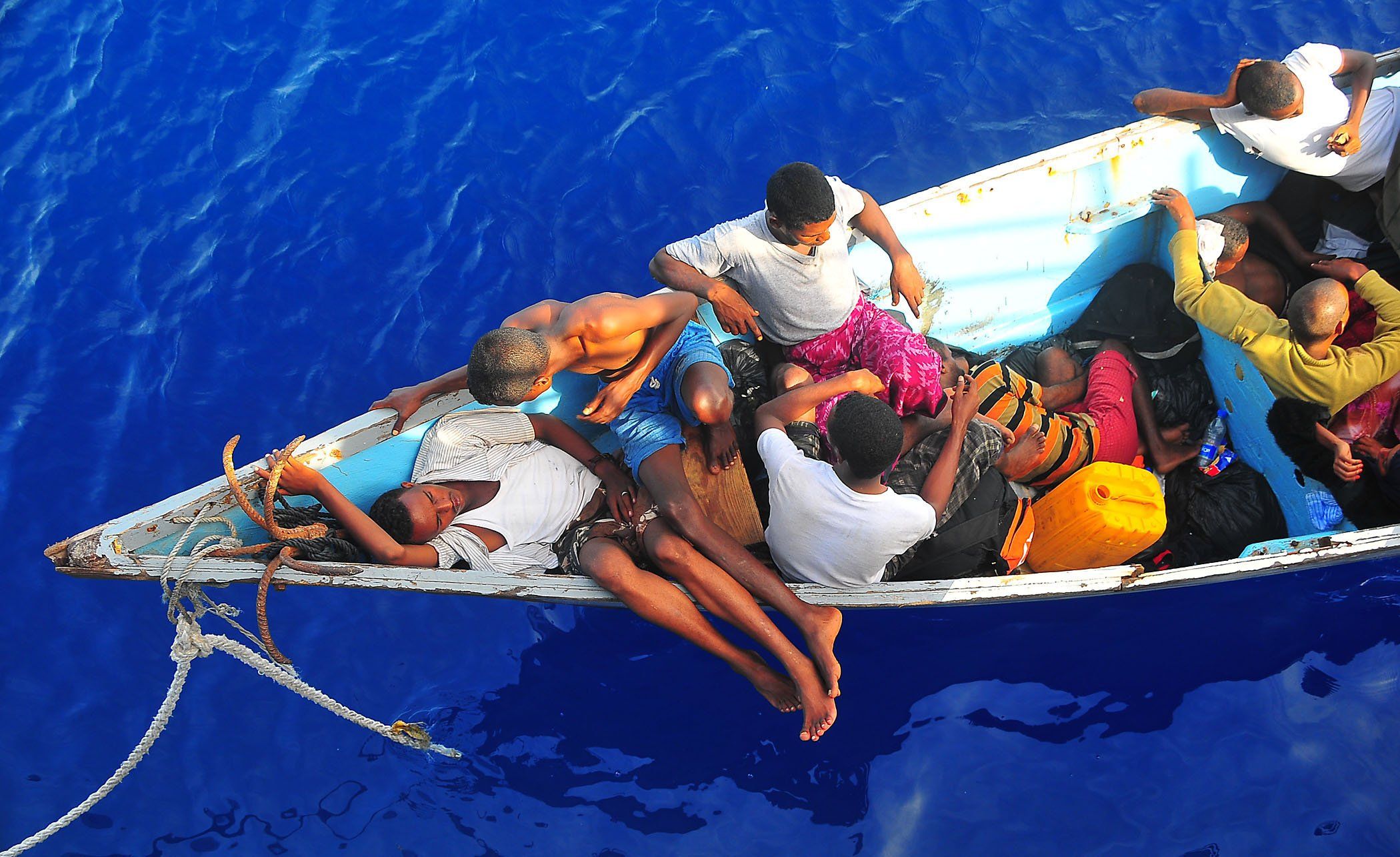 090525-N-4774B-032 
GULF OF ADEN (May 24, 2009) Somali migrants in a disabled skiff wait for assistance from Sailors aboard the guided-missile cruiser USS Lake Champlain (CG 57). The skiff, originally ferrying 52 passengers, was spotted in distress by helicopter pilots assigned to the "Wolfpack" of Helicopter Anti-Submarine Squadron Light (HSL) 45 while patrolling the area. Lake Champlain is deployed as part of the Boxer Expeditionary Strike Group supporting maritime security operations in the U.S. 5th Fleet area of responsibility. (U.S. Navy photo by Mass Communication Specialist 2nd Class Daniel Barker/Released)